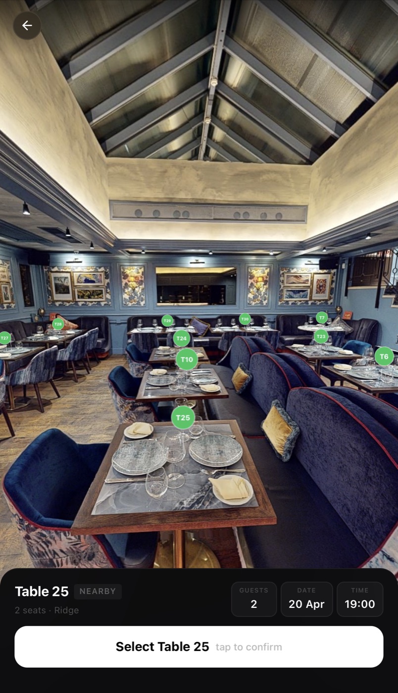 A guest choosing their exact table on RAYN's live seat map of the real dining room